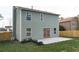 Back of home with a green lawn, newly planted bushes, and access to the backyard via french doors at 6242 Marbut Farms Ln, Lithonia, GA 30058