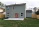 Back of home with a green lawn, newly planted bushes, and access to the backyard via french doors at 6242 Marbut Farms Ln, Lithonia, GA 30058