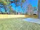 Spacious backyard featuring a freshly poured patio pad and a new wooden privacy fence at 6242 Marbut Farms Ln, Lithonia, GA 30058