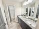 Bright bathroom with granite countertop, dual sinks, and a view into the connected bedroom at 6242 Marbut Farms Ln, Lithonia, GA 30058