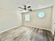 Well-lit bedroom featuring neutral walls, modern ceiling fan, and unique octagonal window at 6242 Marbut Farms Ln, Lithonia, GA 30058