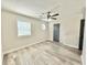 Spacious bedroom featuring neutral walls, modern ceiling fan, and bright window at 6242 Marbut Farms Ln, Lithonia, GA 30058