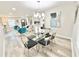 Elegant dining area with modern table, chairs, and view into a naturally lit living room at 6242 Marbut Farms Ln, Lithonia, GA 30058