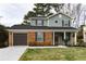 Charming two-story home with brick accents, a well-manicured lawn, and an attached garage at 6242 Marbut Farms Ln, Lithonia, GA 30058
