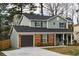 Charming two-story home with brick and siding, an attached garage, and a well-manicured front lawn at 6242 Marbut Farms Ln, Lithonia, GA 30058