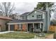 Charming two-story home with brick and siding, an attached garage, and a well-manicured front lawn at 6242 Marbut Farms Ln, Lithonia, GA 30058