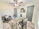 Modern home office featuring glass desk, neutral walls, ceiling fan, and contemporary furnishings at 6242 Marbut Farms Ln, Lithonia, GA 30058