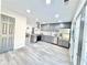 Modern kitchen with stainless steel appliances, grey cabinetry, and an open view to the living space at 6242 Marbut Farms Ln, Lithonia, GA 30058