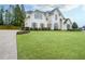 Charming two-story home featuring an expansive front lawn and a long driveway at 6610 River Crest Pt, Suwanee, GA 30024