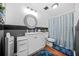 Bathroom with a shower-tub combo, modern vanity, and decorative mirror at 1976 Drennon Ave, Austell, GA 30106