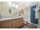 Beautiful bathroom with wood cabinets, double sinks, and a shower-tub combo at 1976 Drennon Ave, Austell, GA 30106