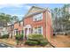 Attractive two-story brick townhouse with blue shutters and a well-maintained lawn at 1976 Drennon Ave, Austell, GA 30106