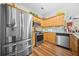 Well-lit kitchen with stainless steel appliances, granite countertops, and wood flooring at 1976 Drennon Ave, Austell, GA 30106