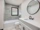 Modern bathroom features white vanity with marble top, gray walls, and gray tile at 2091 Parker Ranch Se Rd, Atlanta, GA 30316