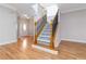 A bright entryway with hardwood floors leads to a carpeted staircase with wrought iron spindles at 3263 Tomeh Way, Tucker, GA 30084