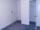 Bedroom with carpet, featuring a door and closet, blending functionality with simple design at 3736 Soapstone Rd, Decatur, GA 30034