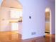 Interior view of arches leading to the kitchen with stainless steel appliances at 3736 Soapstone Rd, Decatur, GA 30034