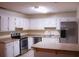 Bright kitchen with an island, tile floors, and stainless steel appliances at 3736 Soapstone Rd, Decatur, GA 30034