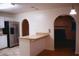 Cozy kitchen featuring stainless steel appliances and a breakfast bar overlooking an arched doorway and hardwood floors at 3736 Soapstone Rd, Decatur, GA 30034