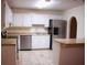Bright kitchen with an island, tile floors, and stainless steel appliances at 3736 Soapstone Rd, Decatur, GA 30034