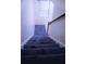 Carpeted staircase features natural light from a top window and a wooden banister, connecting levels with style at 3736 Soapstone Rd, Decatur, GA 30034