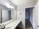 Bright bathroom featuring a double vanity, white doors, and a large mirror at 405 Sora Dr, Stockbridge, GA 30281