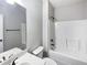 Bathroom featuring a single sink vanity, a mirror, toilet, and tub with a showerhead at 405 Sora Dr, Stockbridge, GA 30281