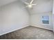Bright bedroom featuring neutral walls, a ceiling fan, and a large window at 405 Sora Dr, Stockbridge, GA 30281