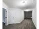 Well-lit hallway with neutral paint, crown molding, and access to multiple rooms at 405 Sora Dr, Stockbridge, GA 30281