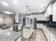 Modern kitchen with granite countertops, stainless steel appliances and dark backsplash at 405 Sora Dr, Stockbridge, GA 30281