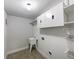 Functional laundry room with cabinets, sink, shelving, and washer/dryer hookups at 405 Sora Dr, Stockbridge, GA 30281
