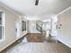 Open-concept living room with hardwood floors, modern lighting, and staircase to the upper level at 405 Sora Dr, Stockbridge, GA 30281