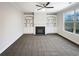 Bright living room features a fireplace flanked by built-in shelving and a ceiling fan at 405 Sora Dr, Stockbridge, GA 30281