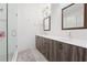 Modern bathroom with double sinks, wood cabinets, and glass-enclosed shower at 68 Adore Se Ct, Atlanta, GA 30315