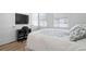 Bright bedroom featuring natural light, wood floors, a TV, and a cozy work space at 68 Adore Se Ct, Atlanta, GA 30315
