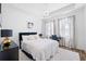 Bright bedroom with a black upholstered bed, desk area, and modern chandelier at 68 Adore Se Ct, Atlanta, GA 30315