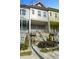 Charming townhome featuring a covered balcony, decorated door and manicured landscaping at 68 Adore Se Ct, Atlanta, GA 30315
