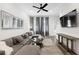 Stylish living room boasts a large sectional sofa, ceiling fan, and a big-screen TV at 68 Adore Se Ct, Atlanta, GA 30315
