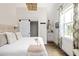 Bright bedroom with modern furnishings, a barn-door closet, and a bathroom featuring a granite vanity at 1015 Loliver Ln, Chattahoochee Hills, GA 30268