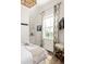 Bright bedroom with a stylish accent wall, natural light from the window, and a cozy, inviting atmosphere at 1015 Loliver Ln, Chattahoochee Hills, GA 30268
