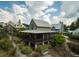 Inviting exterior view with a charming screened-in porch and beautifully landscaped grounds at 1015 Loliver Ln, Chattahoochee Hills, GA 30268