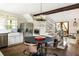 Bright kitchen featuring stainless steel appliances, wooden floors, and a farmhouse sink at 1015 Loliver Ln, Chattahoochee Hills, GA 30268