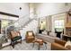 Inviting living room with elegant furnishings, natural light, and access to a stairwell at 1015 Loliver Ln, Chattahoochee Hills, GA 30268