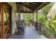 Inviting front porch featuring comfortable rocking chairs, perfect for enjoying the outdoors and neighborhood views at 1015 Loliver Ln, Chattahoochee Hills, GA 30268