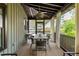 Spacious screened-in porch with dining area, perfect for enjoying outdoor meals and relaxation at 1015 Loliver Ln, Chattahoochee Hills, GA 30268