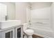 This bathroom features a white vanity and an integrated sink, next to a shower-tub combo at 1534 Norman Xing, Atlanta, GA 30349