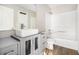 This bathroom has a grey vanity, and integrated sink, and a shower/tub combo at 1534 Norman Xing, Atlanta, GA 30349