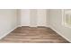 This bedroom features two white closets, wood-look flooring, neutral walls, and a window at 1534 Norman Xing, Atlanta, GA 30349