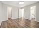 This bedroom has wood-look floors and neutral walls, and three doorways to other spaces at 1534 Norman Xing, Atlanta, GA 30349