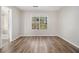 Bright bedroom with wood-look floors, neutral walls, and a window view at 1534 Norman Xing, Atlanta, GA 30349